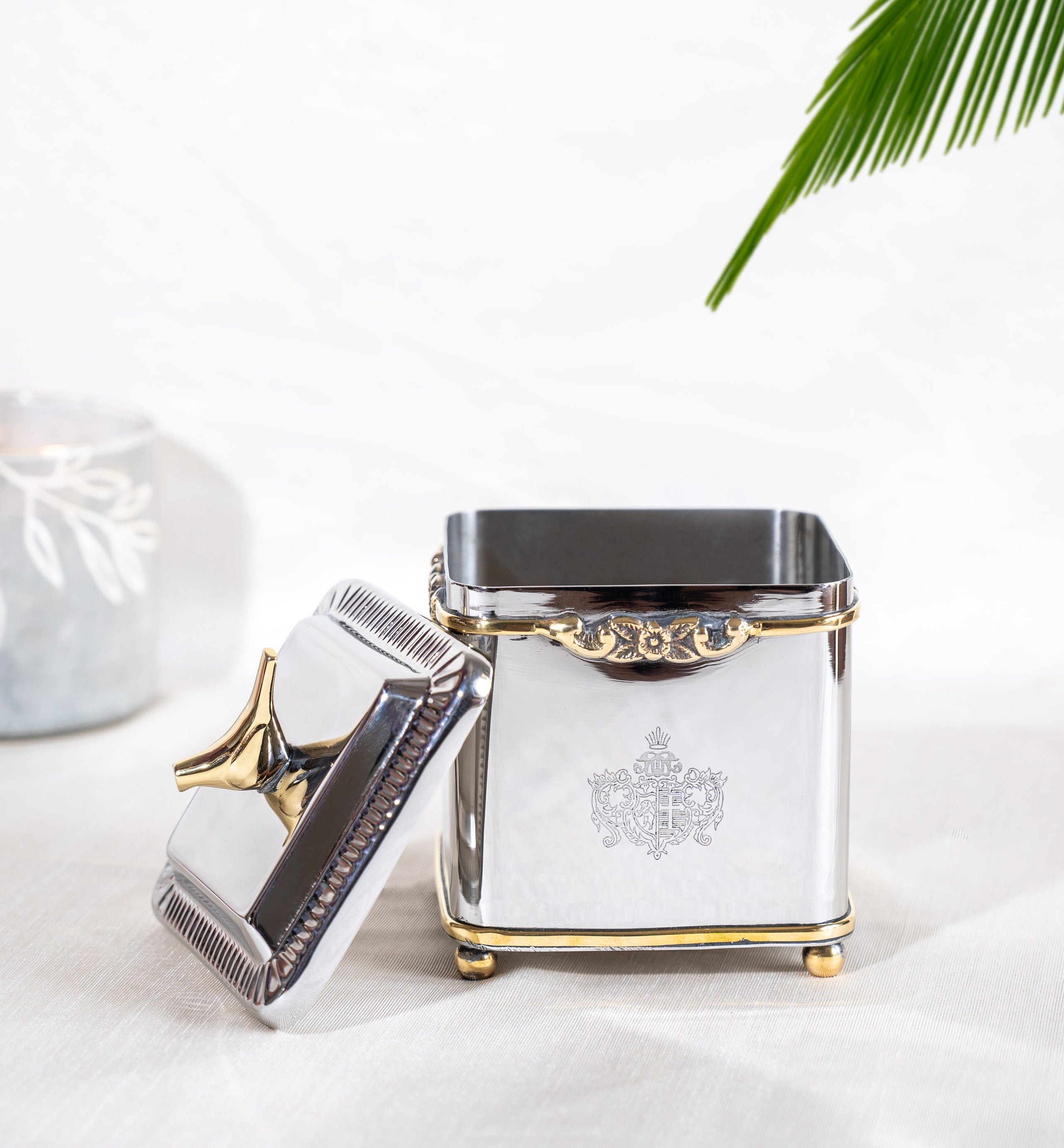 Capacity showing Brass and stainless steel cube canister with bird knob and floral rim
