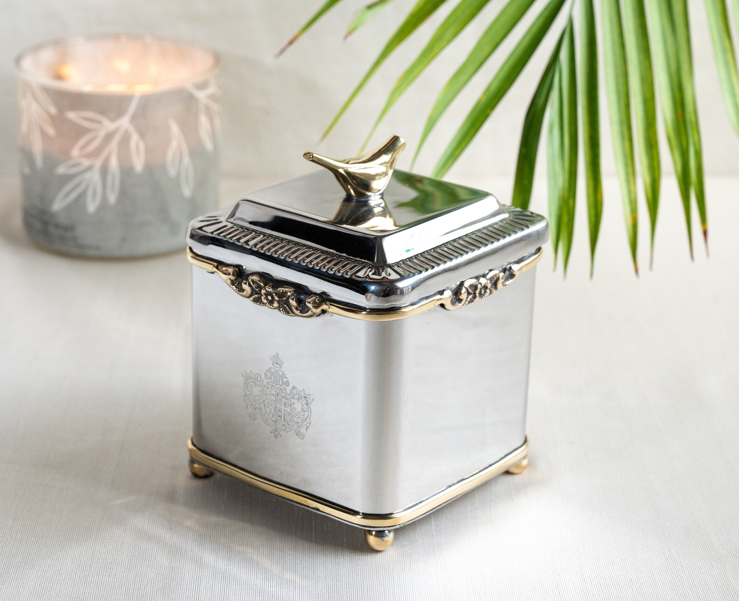 Handcrafted silver tone storage jar with fluted design and gold accents