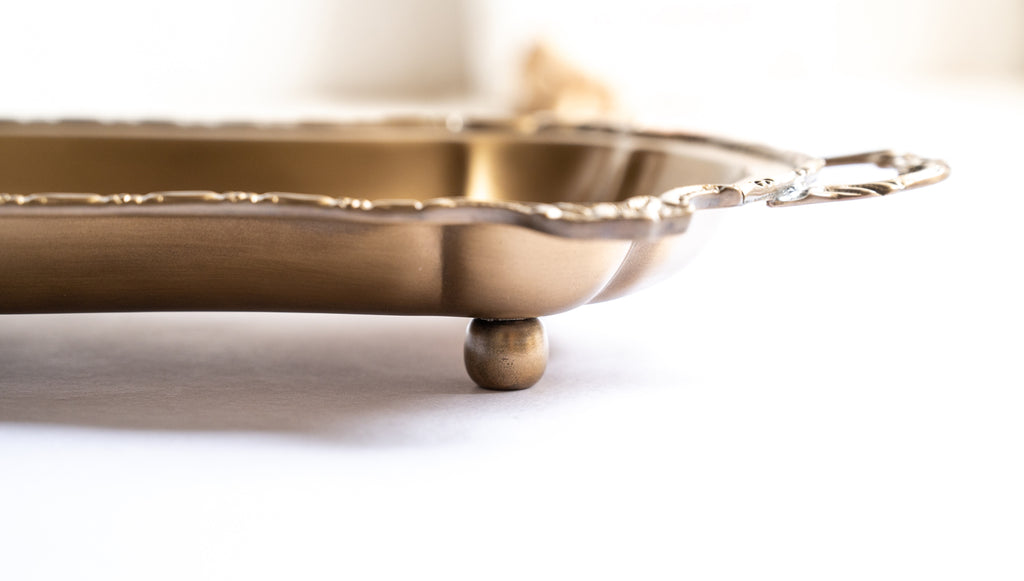 Side viewof decorative catchall tray made from solid brass
