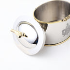 Top view of oval dry fruit container with decorative brass bird on lid